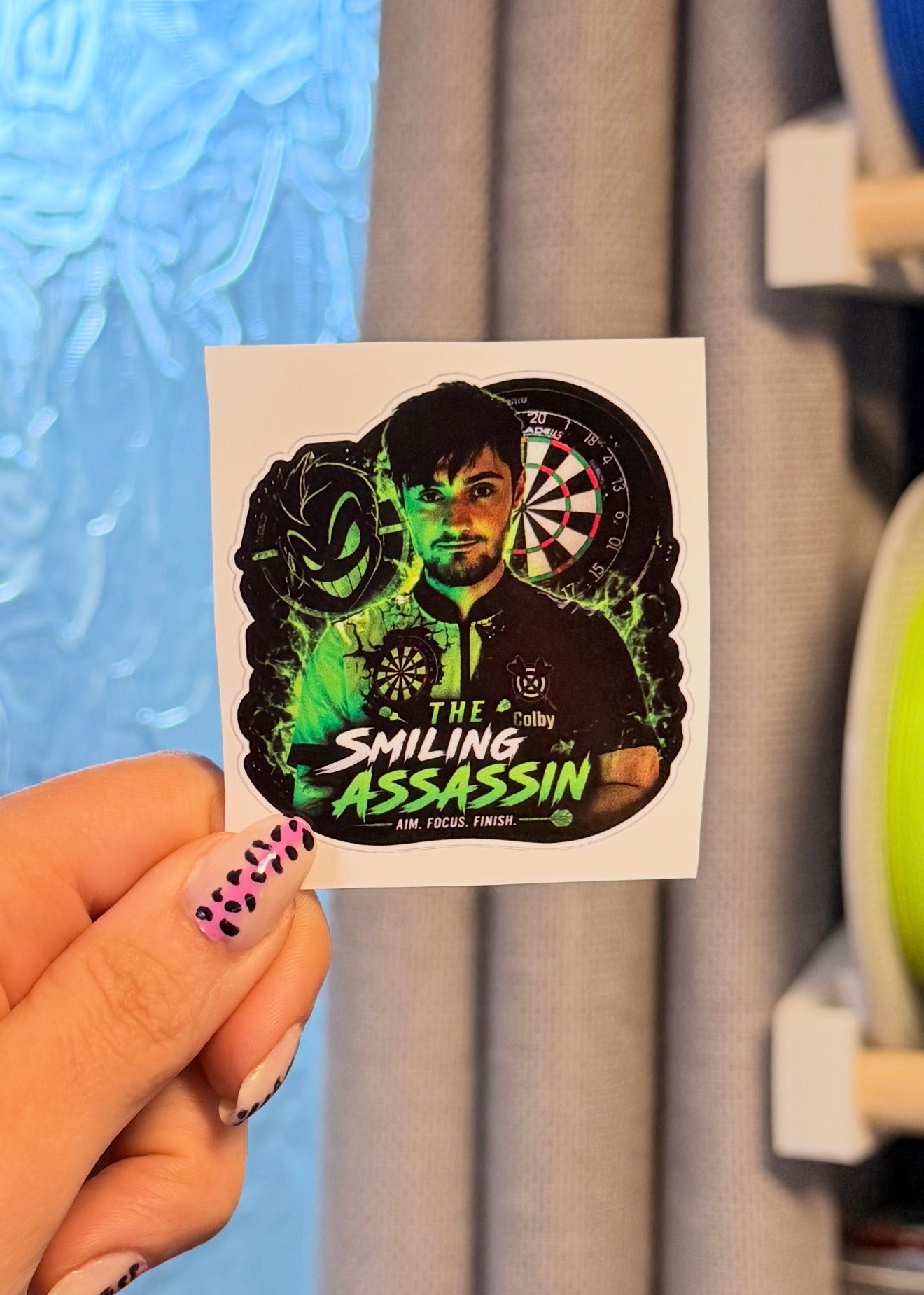 Custom shaped vinyl stickers by Layerworx3d featuring vibrant colors and unique designs on glossy adhesive surfaces.